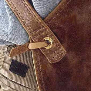 Soft pocketed leather apron with cross back straps and ties at the waist. Regular 28" long x 24.5" wide