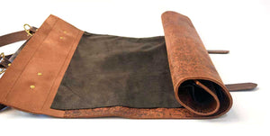 Our handmade Chef Knife Leather Roll with one flap is the perfect gift for anyone who loves to cook and keep their knives in order. Our heavy duty leather chef knife rolls are designed to keep your knives in order, ready to use. It opens up flat for use and rolls up for storage. They are stitched with strong nylon thread and close with 2 brass buckles and offers a convenient shoulder strap.   Color: Earth tones, shades and textures vary based on leather availability