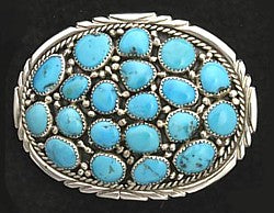 This Turquoise Cluster Sterling Belt Buckle by artist Arnold Goodluck holds a spectacular offering of natural, turquoise stones. These gorgeous stones are bezel set on and surrounded in Sterling.