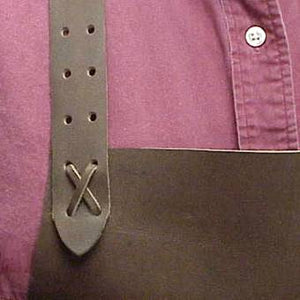 Basic heavy-duty long leather shop apron, around the head adjustable strap. Secured at the waist with a leather thong tie with grommets. Size: 38" L x 24.5" W